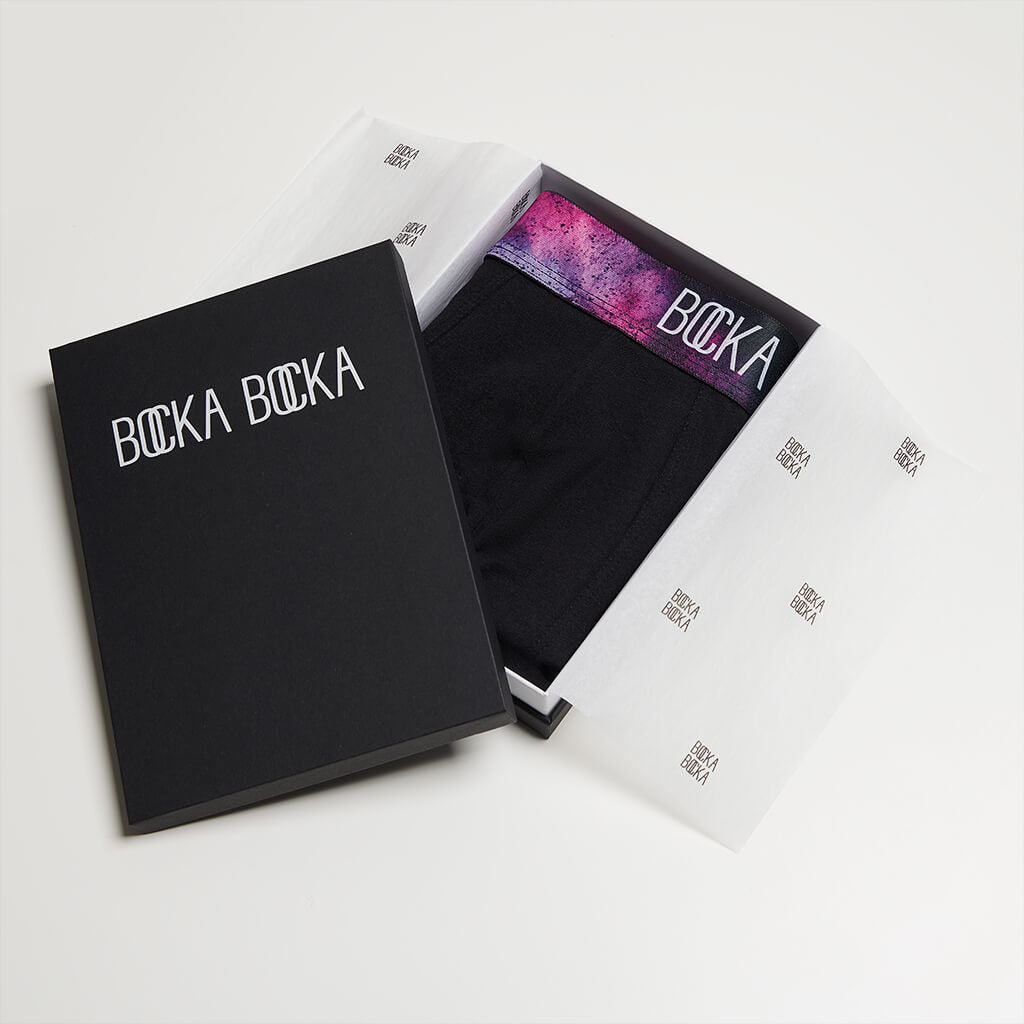 A pair of Bocka Bocka Galassia Midnight mens designer trunks in a Bocka Bocka gift box