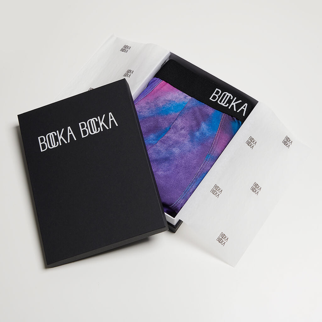 A pair of Bocka Bocka Galassia Supernova mens designer trunks in a Bocka Bocka gift box